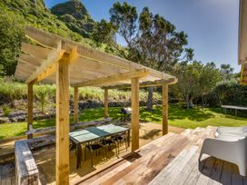An outdoor dining area with a table and chairs at Pacific Vista - Hawkes Bay Havelock North