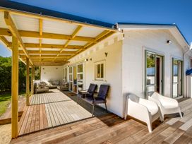 An outdoor space with a deck and seating at Pacific Vista - Hawkes Bay in Havelock North