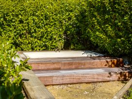 A sink with wooden steps surrounded by greenery at Pacific Vista - Hawkes Bay, Havelock North