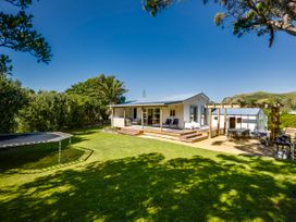 A house with a deck and garden furniture at Pacific Vista - Hawkes Bay in Havelock North