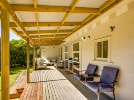 An outdoor patio with chairs and a table at Pacific Vista - Hawkes Bay, Havelock North