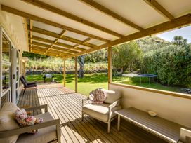 An outdoor patio with seating and a trampoline at Pacific Vista - Hawkes Bay in Havelock North