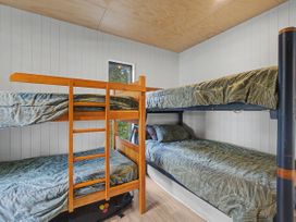 A bedroom with a bunk bed at Modern Coastal Tree House - Whangamata Retreat, Whangamata