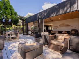 A sitting area with outdoor furniture at Modern Coastal Tree House - Whangamata Retreat in Whangamata