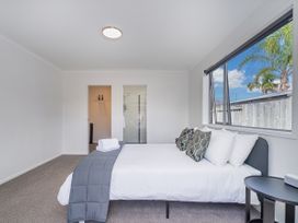 A bedroom with a bed and window at Sweet As on Aquila - Whitianga Holiday Home Whitianga