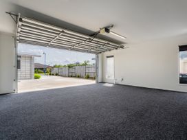 A garage with a large opening towards the exterior at Sweet As on Aquila - Whitianga Holiday Home Whitianga