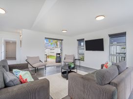 A living room with a couch and television at Sweet As on Aquila - Whitianga