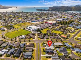 An aerial view of a coastal town with houses and commercial buildings at Sweet As on Aquila - Whitianga