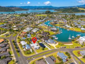 Aerial view of residential area with houses and waterways at Sweet As on Aquila - Whitianga Holiday Home, Whitianga