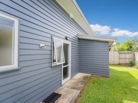 A house exterior with a door and window at Sweet As on Aquila - Whitianga Holiday Home Whitianga