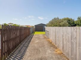 An outdoor pathway leading to a shed at The Schieck Shack - Whitianga