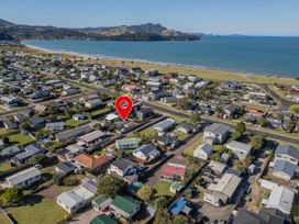 An aerial view of houses near the beach at The Schieck Shack - Whitianga