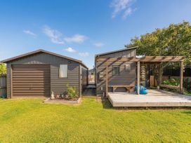 An outdoor area with two structures and a deck at The Schieck Shack - Whitianga Holiday Home Whitianga