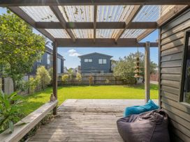 An outdoor area with a deck and garden at The Schieck Shack - Whitianga