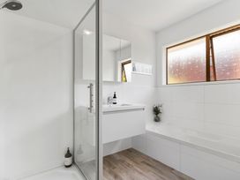A bathroom with a shower, bathtub, and sink at Moana - Onehunga Holiday Home in Auckland