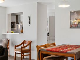 A dining room with a table and chairs visible at Moana - Onehunga Holiday Home in Auckland