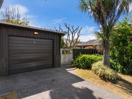 A garage with a driveway and plants at Moana - Onehunga Holiday Home in Auckland