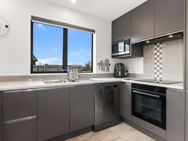 A kitchen with a sink and oven at Riverside Retreat - Waipu Holiday Home