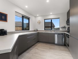 A kitchen with sink and coffee machine at Riverside Retreat - Waipu Holiday Home