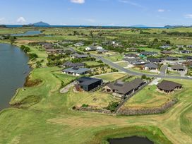 Aerial view of houses and river at Riverside Retreat - Waipu Holiday Home in Waipu