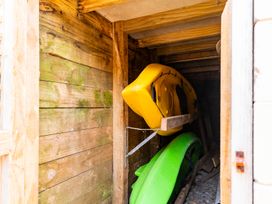 A shed containing yellow and green kayaks at Mangawhai Marvel - Mangawhai Heads