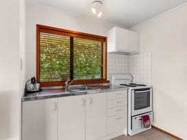 A kitchen with a sink and stove at Mangawhai Marvel - Mangawhai Heads