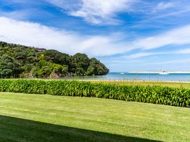 A landscape view with grass and water at Mangawhai Marvel - Mangawhai Heads
