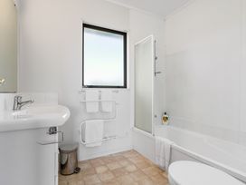 A bathroom with a sink, shower, toilet and bathtub at Bayview Cottage - Whakamarama Holiday Home in Whakamarama