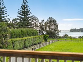 A view of trees and water at Bayview Cottage - Whakamarama Holiday Home in Whakamarama