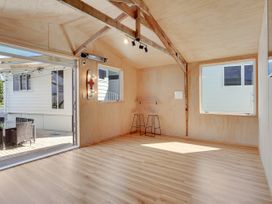 An indoor area with a table and chairs at Raglan Holiday Home