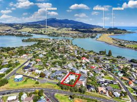 An aerial view of residential area with water features near Raglan Holiday Home 