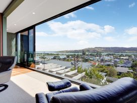 A living room with a view of the landscape at Raglan Holiday Home