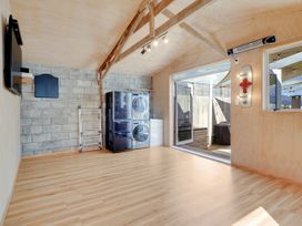 A utility room with a washing machine and dryer at Raglan Holiday Home
