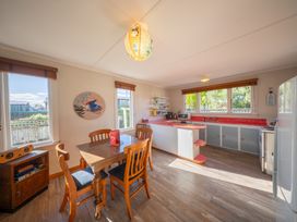 A kitchen with a table and chairs at Darling on Dorizac - Te Anau Holiday Home Te Anau