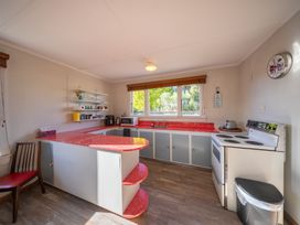 A kitchen with counter and stove at Darling on Dorizac - Te Anau Holiday Home, Te Anau