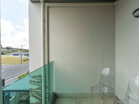 A balcony with two transparent chairs at Lake Taupo Holiday Home Taupo