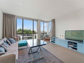 A living room with a sofa and television at Lake Taupo Holiday Home in Taupo
