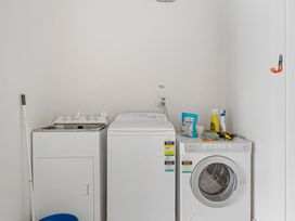 A laundry room with a washing machine and dryer at Lake Taupo Holiday Home in Taupo