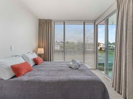 A bedroom with a bed and window at Lake Taupo Holiday Home in Taupo