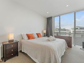 A bedroom with a bed and nightstand at Lake Taupo Holiday Home in Taupo