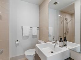 A bathroom with a toilet, sink, and shower at Lake Taupo Holiday Home in Taupo