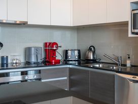 A kitchen with appliances including a kettle, toaster, and coffee machine at Lake Taupo Holiday Home in Taupo