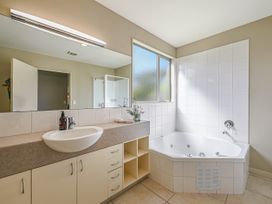 A bathroom with a bathtub and sink at Vintners - Renwick Holiday Home in Blenheim