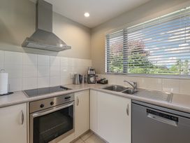 A kitchen with stove, oven, sink, and dishwasher at Vintners - Renwick Holiday Home Blenheim