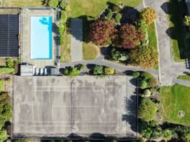 An outdoor space with a swimming pool and a tennis court at Vintners - Renwick Holiday Home Blenheim