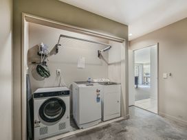A laundry room with a washing machine and dryer at Vintners - Renwick Holiday Home, Blenheim