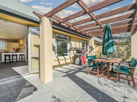 An outdoor patio with a table and chairs at Vintners - Renwick Holiday Home, Blenheim