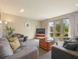 A living room with a television and coffee table at Vintners - Renwick Holiday Home Blenheim