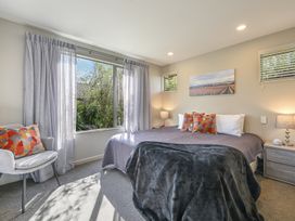 A bedroom with a bed and window at Vintners - Renwick Holiday Home in Blenheim