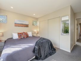 A bedroom with a large bed and bedside tables at Vintners - Renwick Holiday Home in Blenheim